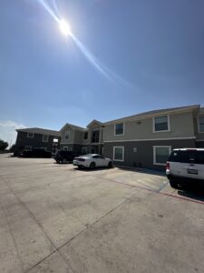 La Joya Apartments Exterior with Parked Cars Side View