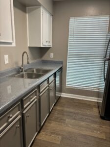Avalon Floor Plan Kitchen Dishwashing with White Cabinetsand Fridge View by Trailwood Village Apartments - Unit 714
