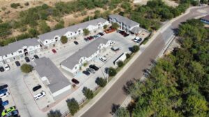 Bird's-eye view of La Joya Apartments, a residential community, highlighting a dense arrangement of cars throughout the neighborhood