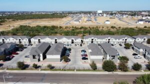 Overhead perspective of La Joya Apartments, a residential area filled with cars parked in a large parking lot