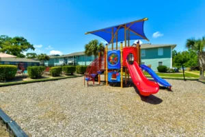 Palm Isle Apartment Homes Exterior Playground View in Biloxi, MS Photo