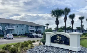 Palm Isle Apartment Homes Exterior View with Monument Signage Logo in Biloxi, MS Photo