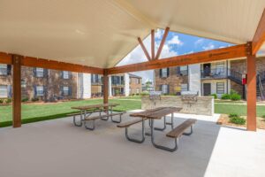 Covered patio at Edgewater Pointe Apartments, featuring a stylish BBQ and grill area for outdoor gatherings