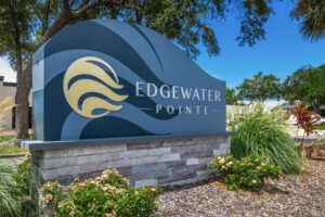 Image of Edgewater Pointe Apartments in Biloxi, MS, showcasing the building's exterior and its notable logo